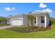 Beautiful single Gathering home exterior showcasing well-manicured lawn and neutral-colored facade at 29156 Coral Harbour Dr, Englewood, FL 34223