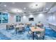 Well-lit game room offers comfortable tables, a large television, and stylish decor for entertainment and relaxation at 29156 Coral Harbour Dr, Englewood, FL 34223