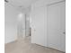Hallway area featuring light tile floors, white walls, and access to bedrooms and closets at 29156 Coral Harbour Dr, Englewood, FL 34223