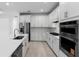 Stylish kitchen with white cabinets, stainless steel appliances, and gas cooktop at 29156 Coral Harbour Dr, Englewood, FL 34223