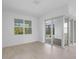 Spacious living room with sliding glass doors leading to outdoor patio and large window to allow natural light at 29156 Coral Harbour Dr, Englewood, FL 34223