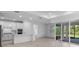 Open-concept kitchen and living area with large windows, modern finishes, and spacious design at 29156 Coral Harbour Dr, Englewood, FL 34223