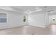 Bright, airy living room featuring neutral tile flooring, recessed lighting, and windows for natural light at 29156 Coral Harbour Dr, Englewood, FL 34223