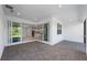 A covered patio with brick flooring, large sliding doors, and natural light creates an inviting indoor/outdoor living space at 29156 Coral Harbour Dr, Englewood, FL 34223