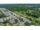 Aerial view of a home backing up to a utility easement in a neighborhood with mature trees and landscaping at 3009 Banyan Hill Ln, Land O Lakes, FL 34639