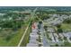 Aerial view of a home backing up to a utility easement in a neighborhood near a road and recreational area at 3009 Banyan Hill Ln, Land O Lakes, FL 34639