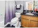 Cozy bathroom featuring a shower/tub combination, toilet, vanity with sink, and neutral wall colors at 3009 Banyan Hill Ln, Land O Lakes, FL 34639
