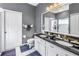 Elegant bathroom featuring double sinks, granite countertops, and a tiled shower at 3009 Banyan Hill Ln, Land O Lakes, FL 34639