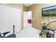 Functional bedroom area with a closet, tile flooring, and mounted television at 3009 Banyan Hill Ln, Land O Lakes, FL 34639