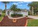 Well-maintained home with landscaped yard, mature palms, and a two-car garage at 3009 Banyan Hill Ln, Land O Lakes, FL 34639