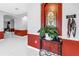 Bright foyer with red accent walls, arched doorways, and dog leash rack at 3009 Banyan Hill Ln, Land O Lakes, FL 34639