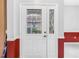 Elegant front door with decorative glass panels and sidelight, providing a grand entrance at 3009 Banyan Hill Ln, Land O Lakes, FL 34639