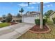 Charming single-story home with a well-maintained lawn, mature landscaping, and a two-car garage at 3009 Banyan Hill Ln, Land O Lakes, FL 34639