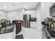 Kitchen featuring stainless steel appliances, white cabinets, and black countertops at 3009 Banyan Hill Ln, Land O Lakes, FL 34639