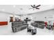 Bright living room with white tile flooring, gray couches, and open concept at 3009 Banyan Hill Ln, Land O Lakes, FL 34639