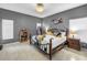 Comfortable main bedroom with a wrought iron bed frame, and lots of natural light at 3009 Banyan Hill Ln, Land O Lakes, FL 34639