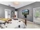 Spacious main bedroom with a cozy bed, TV, and access to a private balcony at 3009 Banyan Hill Ln, Land O Lakes, FL 34639