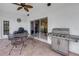 Entertaining covered patio with grill, fan and furniture at 3009 Banyan Hill Ln, Land O Lakes, FL 34639