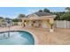 Community pool house with convenient changing rooms, lounge seating, and tropical landscaping at 3009 Banyan Hill Ln, Land O Lakes, FL 34639