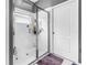 Bright, white tiled shower with glass door in well-maintained bathroom at 3009 Banyan Hill Ln, Land O Lakes, FL 34639
