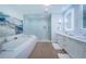Bright bathroom featuring a tub, glass shower, double vanity, and stylish decor at 301 1St S St # 3004, St Petersburg, FL 33701