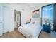 Cozy bedroom with light wood floors, bright white walls, ensuite bathroom and city views at 301 1St S St # 3004, St Petersburg, FL 33701
