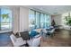 Community room features tables, chairs and ocean view at 301 1St S St # 3004, St Petersburg, FL 33701