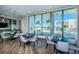 Community room features tables, chairs and ocean view at 301 1St S St # 3004, St Petersburg, FL 33701