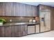 Modern kitchen features wood grain cabinets, stainless steel appliances and quartz countertops at 301 1St S St # 3004, St Petersburg, FL 33701