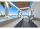 Outdoor kitchen with a bar area and grill overlooking the pool and ocean at 301 1St S St # 3004, St Petersburg, FL 33701