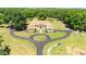 Aerial view of a grand home with a circular driveway and mature landscaping at 30723 Reed Rd, Dade City, FL 33523