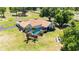 Stunning aerial view of a single-Gathering home with a screened pool, lush landscaping, and a spacious yard in a rural community at 30723 Reed Rd, Dade City, FL 33523