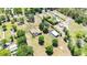 Aerial view of a property featuring a home, pool, large outbuilding, and mature trees at 30723 Reed Rd, Dade City, FL 33523