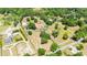 Vast aerial view shows the residence on a large lot with mature trees and multiple structures at 30723 Reed Rd, Dade City, FL 33523