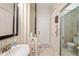 Neutral bathroom with a glass shower door, vanity, and closet for ample storage space at 30723 Reed Rd, Dade City, FL 33523