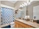 Bathroom with a shower and bathtub combination and wood vanity and light fixture at 30723 Reed Rd, Dade City, FL 33523