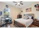 Bedroom featuring a ceiling fan, a large window, and sports-themed decorations at 30723 Reed Rd, Dade City, FL 33523