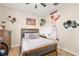 Bedroom featuring sports-themed decorations, a ceiling fan, and a window for natural light at 30723 Reed Rd, Dade City, FL 33523