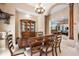 Elegant dining area with a large wooden table and chairs, complemented by a stylish chandelier at 30723 Reed Rd, Dade City, FL 33523