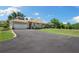 Home's exterior with well-manicured lawn, attached garage and paved driveway at 30723 Reed Rd, Dade City, FL 33523