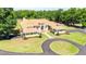 A luxurious single-Gathering home with a circular driveway, well-manicured lawn, and elegant architectural details at 30723 Reed Rd, Dade City, FL 33523
