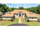 Beautiful single-story home with elegant architecture, well-maintained lawn, and paved walkway at 30723 Reed Rd, Dade City, FL 33523