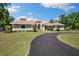 Charming single-story home with well-manicured lawn and circular driveway at 30723 Reed Rd, Dade City, FL 33523