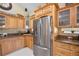 Bright kitchen featuring stainless steel refrigerator and beautiful custom cabinets at 30723 Reed Rd, Dade City, FL 33523