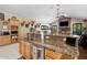 Gourmet kitchen with granite countertops, stainless steel appliances, and custom wood cabinets at 30723 Reed Rd, Dade City, FL 33523