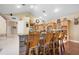 Kitchen bar with stone and seating for four, overlooking the rest of the large kitchen at 30723 Reed Rd, Dade City, FL 33523