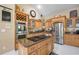 Gourmet kitchen with stainless steel appliances, custom wood cabinetry, and a spacious center island at 30723 Reed Rd, Dade City, FL 33523