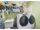 Laundry room with a Whirlpool washer and dryer, a utility sink, and wire shelving at 30723 Reed Rd, Dade City, FL 33523