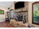 Stone fireplace with wooden mantle and hearth with lots of natural light at 30723 Reed Rd, Dade City, FL 33523