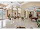 Open-concept living area boasts tall ceilings, stylish columns, and seamless transition to dining and recreation spaces at 30723 Reed Rd, Dade City, FL 33523